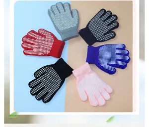 Detailed view of children's colorful knitted anti-slip gloves with white dot grips for kids.
