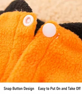 Detailed shot of pet clothing snap button design, soft orange fleece material for easy wear.
