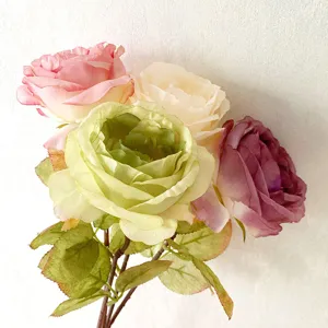 Close up of vintage artificial silk roses bouquet with burnt edge detail for home room decor.