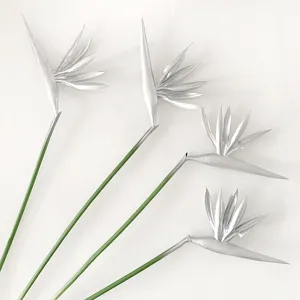 Detailed view of silver artificial Bird of Paradise flowers with green stems for home decor.