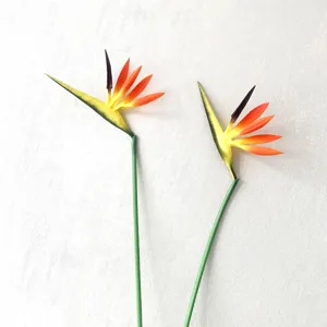 Detailed view of artificial bird of paradise flower, realistic silk flower stems for home decor.