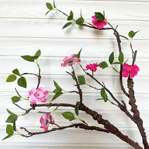 Ramo artificiale con fiori rosa e foglie verdi, ideale per decorazioni domestiche in stile zen.