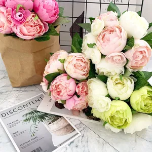 Detail shot of Nordic artificial peony and camellia flower bouquet arrangement in a kraft bag.