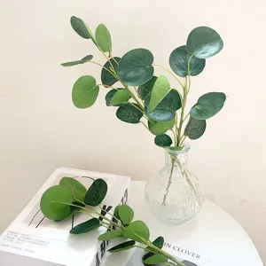 Artificial golden pocket leaf branch in glass vase, realistic green leaves for home decor.