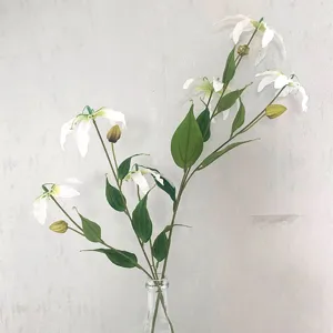 Artificial Gloriosa lily flower detail shot, elegant floral arrangement in a glass vase.