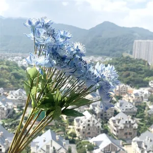 Detailed closeup view of blue artificial dandelion silk flowers for elegant room decor.