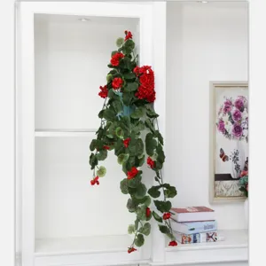 Artificial hanging flower vine detail, realistic red floral decor for wall and room.