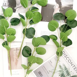 Detailed view of artificial golden coin leaf branches, perfect for floral arrangement decor.