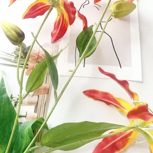 Artificial Gloriosa lily flower detail, vibrant red yellow petals for home decor styling.