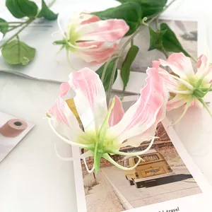 Artificial Gloriosa lily flower detail close up, pink and white floral arrangement decor.