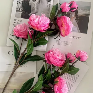 Detailed shot of artificial pink peony tea rose branches, ideal for home decor and photography props.