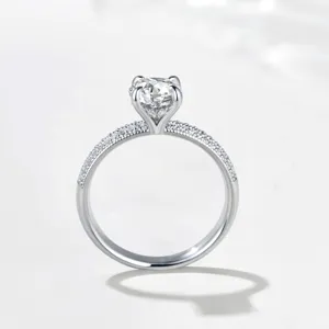 Close-up detail of the 1-carat moissanite ring with pave half-band and exquisite four-prong setting.