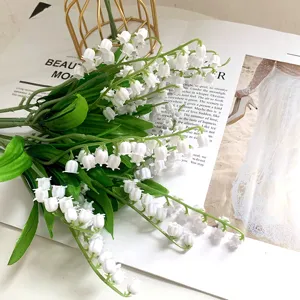 Artificial lily of the valley bouquet fake flowers for home wedding decor, fresh white floral detail.