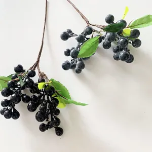 Artificial black berry branches with green leaves for home decor and floral arrangement design.