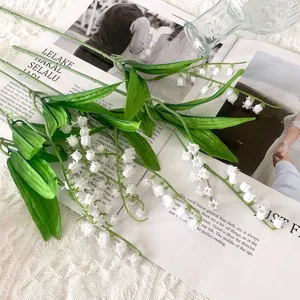 Artificial Lily of the Valley flower detail, soft plastic white floral bouquet for home decor.