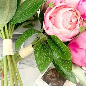 Close-up of artificial peony bouquet, silk flower details, elegant floral decor for home.