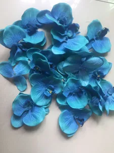 Blue artificial orchid flower heads, detail view for DIY crafts, shoes and hats accessories.