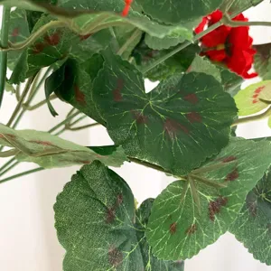 Close-up of artificial begonia flower leaves with realistic red spots and clear texture details.