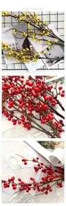 Detailed close-up view of artificial red and yellow berry branches for home floral decor.