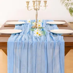 Light blue crinkle chiffon table runner detail shot showcasing fine texture and elegant wedding decor.