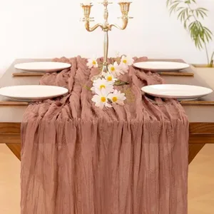 Detailed view of dusty rose crinkle chiffon table runner, elegant wedding party table decor setup.