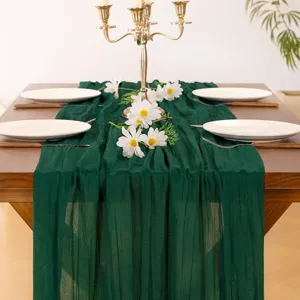 Textured dark green gauze table runner close-up shot, ideal for wedding party decoration.
