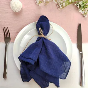 Dark blue wrinkled cloth napkin detail view for wedding party and western dining table decor.