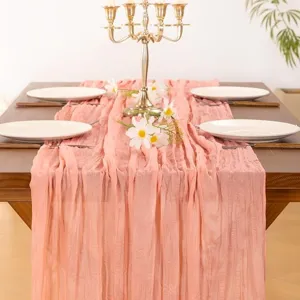 Pink gauze table runner detail, elegant crinkled fabric for wedding party dining table decor.