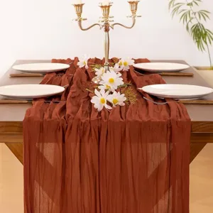 Wrinkled cheesecloth table runner in rust brown, perfect for rustic wedding party and home decor.