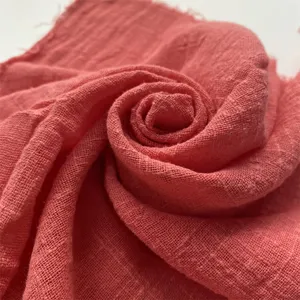 Coral pink crinkled fabric napkin for elegant wedding party table decor and versatile home use.