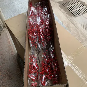 Artificial red berry branches packaging detail, festive winterberry stems for floral arrangement.