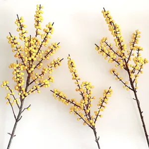 Detailed close-up view of artificial yellow winterberry branch, realistic floral decor.