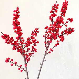Close-up detail of artificial red winterberry branches, vibrant festive floral decor.