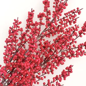 Close-up detail of artificial red berry branches, vibrant floral decor for holiday arrangement.