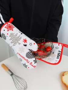 Christmas oven mitt and pad set detail, featuring festive snowflake and tree print.