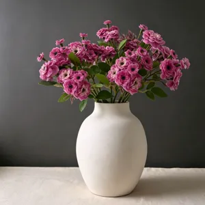 Artificial pink rambler rose bouquet in white ceramic vase for home decor wedding photo props
