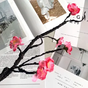 Close-up of artificial peach blossom branch, ideal for elegant home decor and floral arrangement.