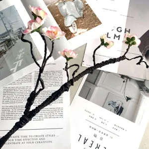 Artificial silk peach blossom branch for home living room decor and floral arrangement details.