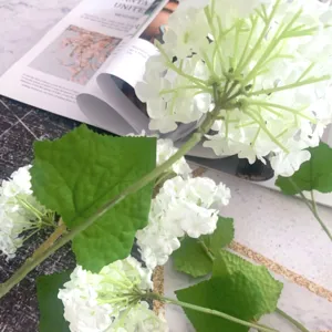 Artificial white hydrangea single branch with green leaves for wedding flower decoration.