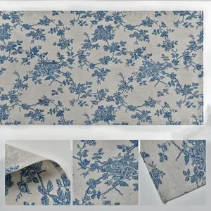 Close-up details of cotton linen table runner showing blue floral print fabric texture.