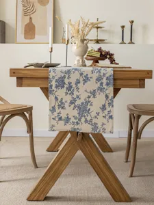 Detailed view of blue floral cotton linen table runner, rustic Nordic dining table decor.