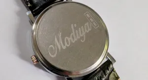 Detailed view of Modiya men's quartz watch back cover with classic black leather strap.
