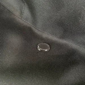 Waterproof apron fabric detail close-up showing anti-fouling and oil-proof performance.