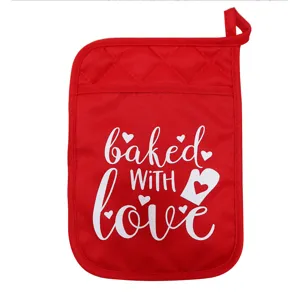 Red kitchen pot holder with pocket and baked with love text print, heat resistant fabric.