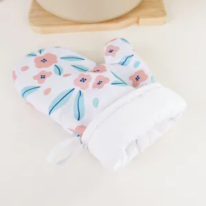Close up detail of pastoral style floral oven mitt with heat resistant material for kitchen baking.