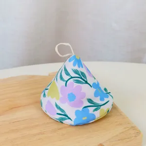 Detailed close-up of pastoral floral fabric pot handle cover, heat-insulating design.