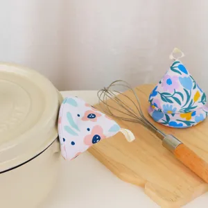 Floral fabric pot handle cover detail, cute triangular heat insulating kitchen mitt.