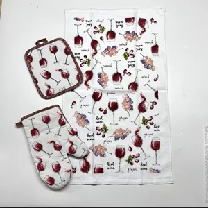 Kitchen textile set includes oven mitt, pot holder and tea towel with red wine grape print.