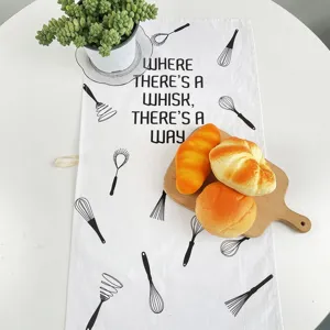 Canovaccio da cucina in cotone stampato, dettaglio, design minimalista in bianco e nero.