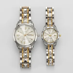 Detailed view of luxury quartz couple watches with gold and silver pyramid links and rhinestone dial.